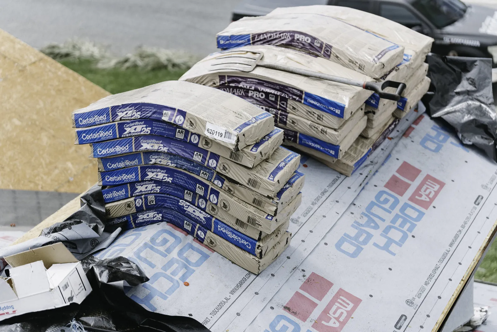 Roofing shingle bundles staged for a residential installation