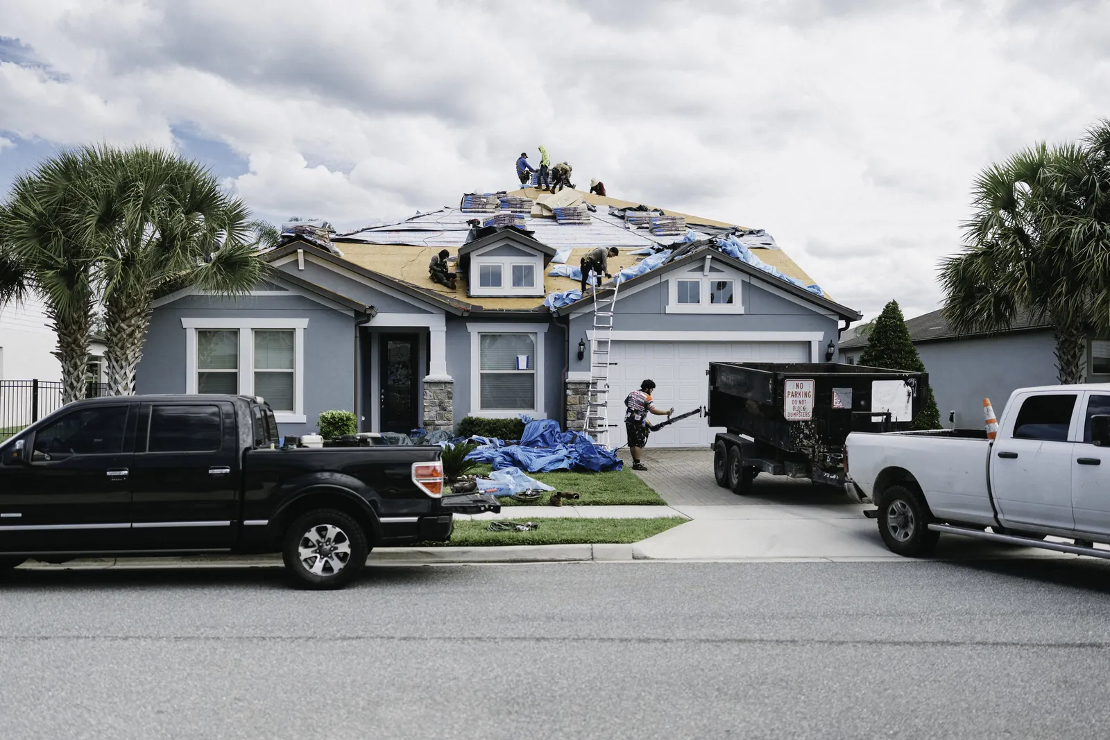 Residential roofing jobsite viewed from the street