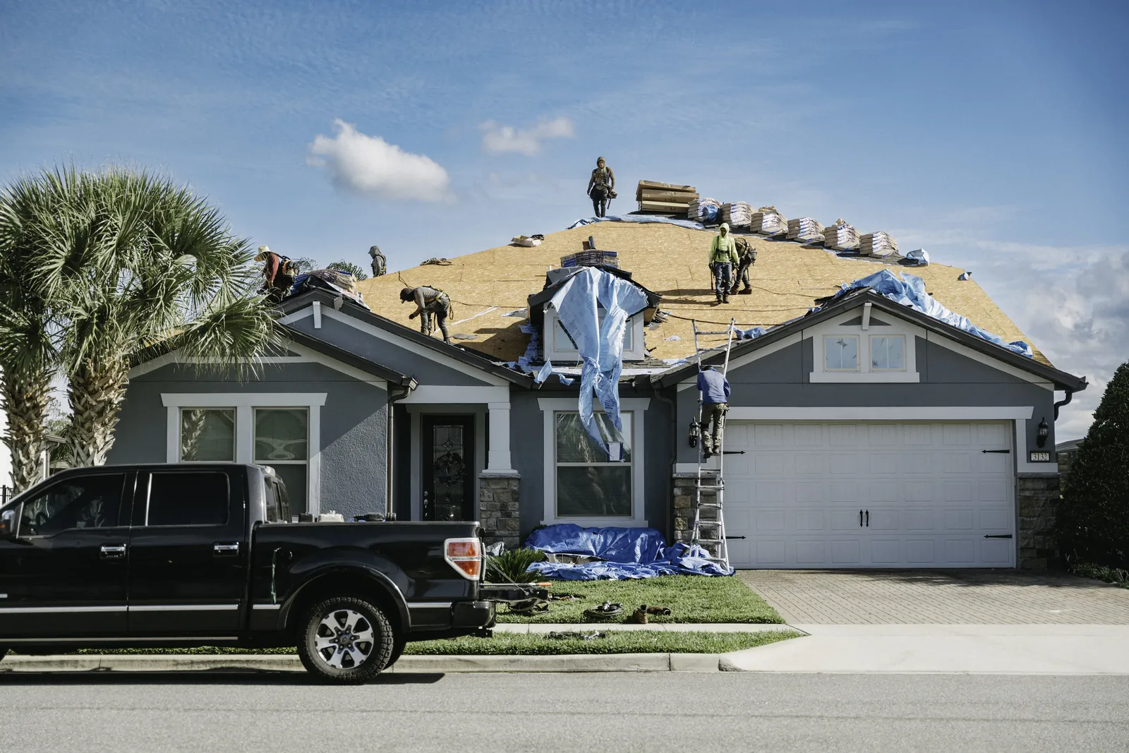 Roofing crew on a residential roof ready for a professional assessment