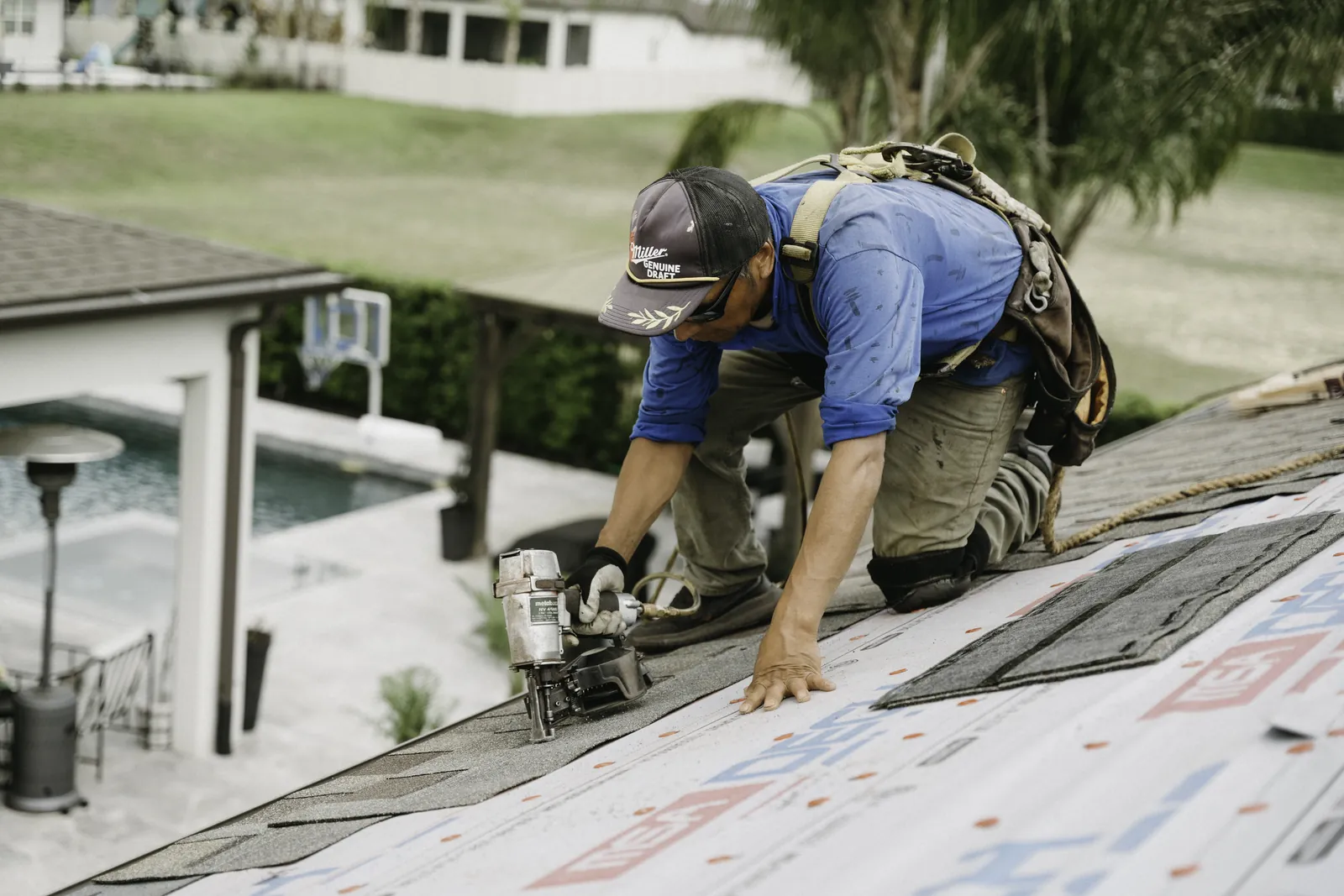 Roofer preparing a roof-edge detail during a repair
