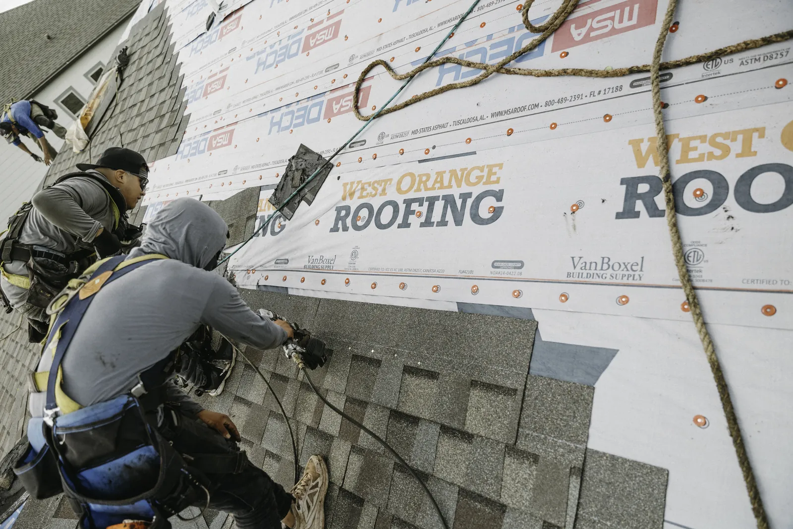 Roofer cutting roofing material for a precise roof detail