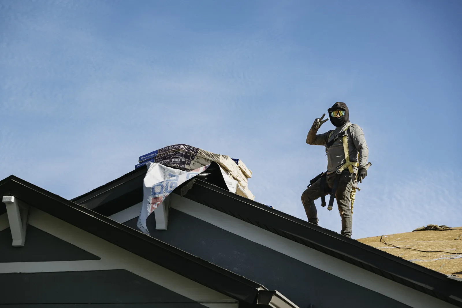 Roofer inspecting a gable roof section