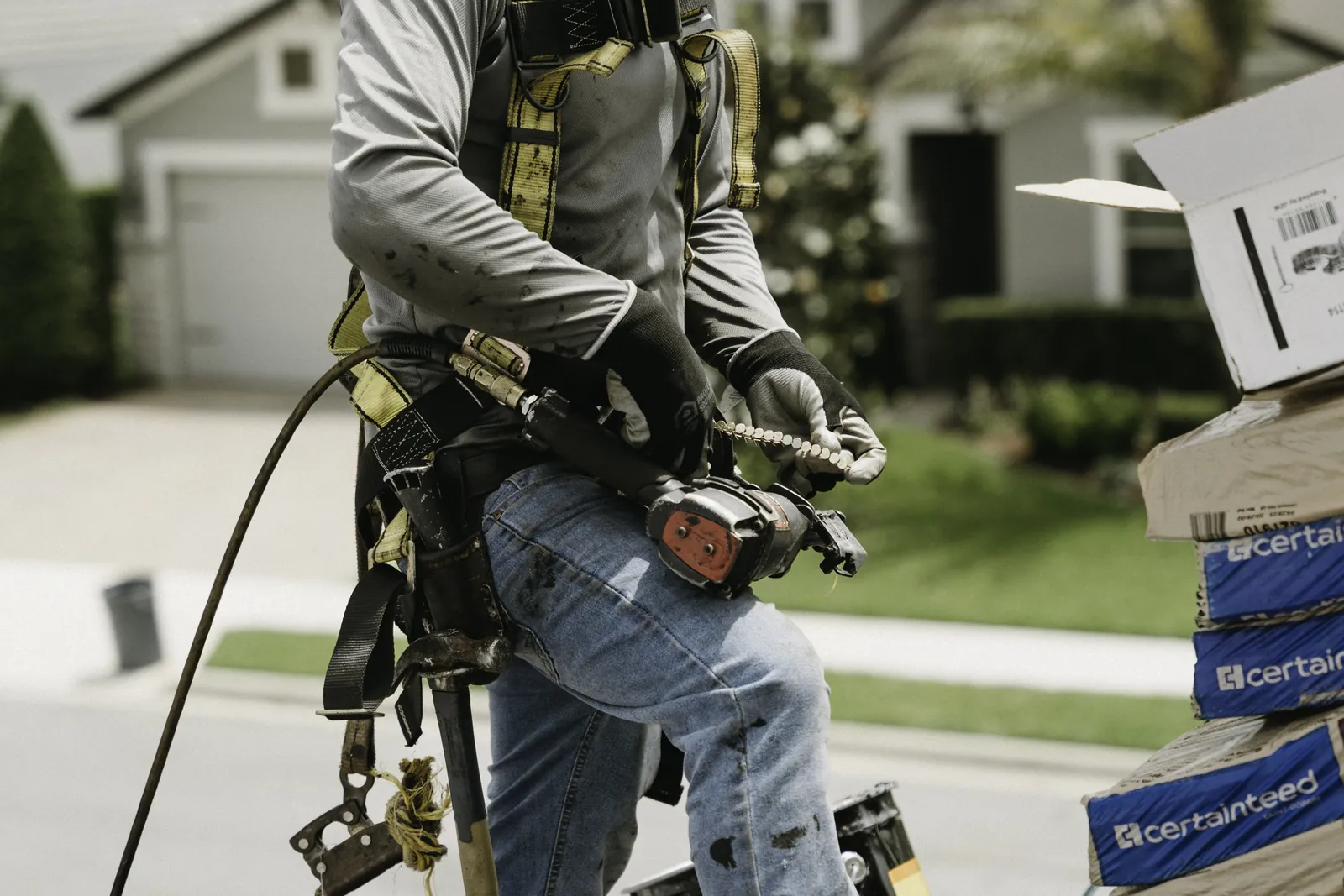 Roofing professional's tool belt prepared for repair work
