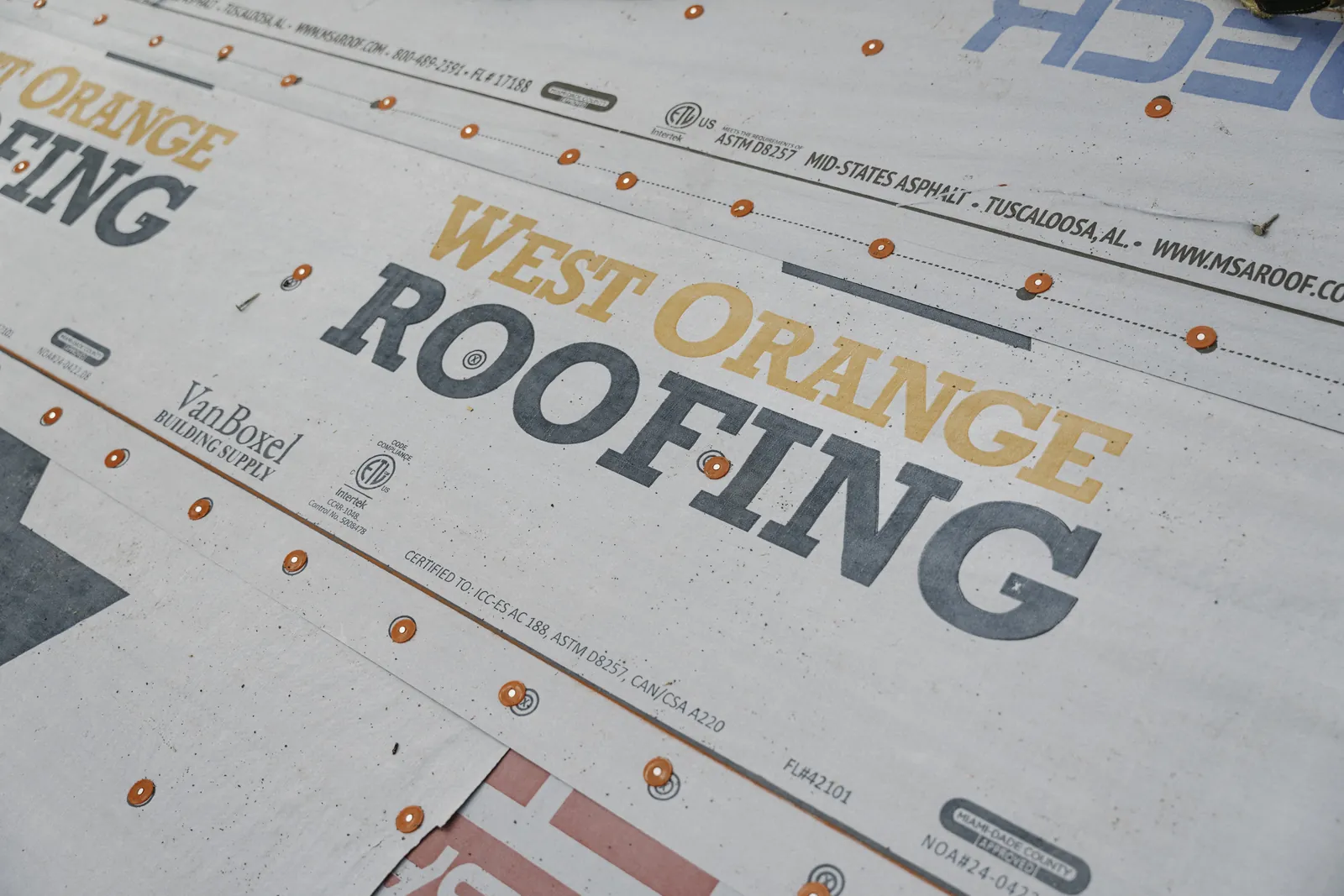 Roofer trimming a shingle edge during repair work
