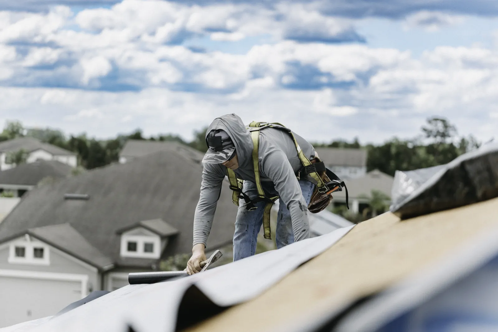 Roofer working carefully along a residential roof edge