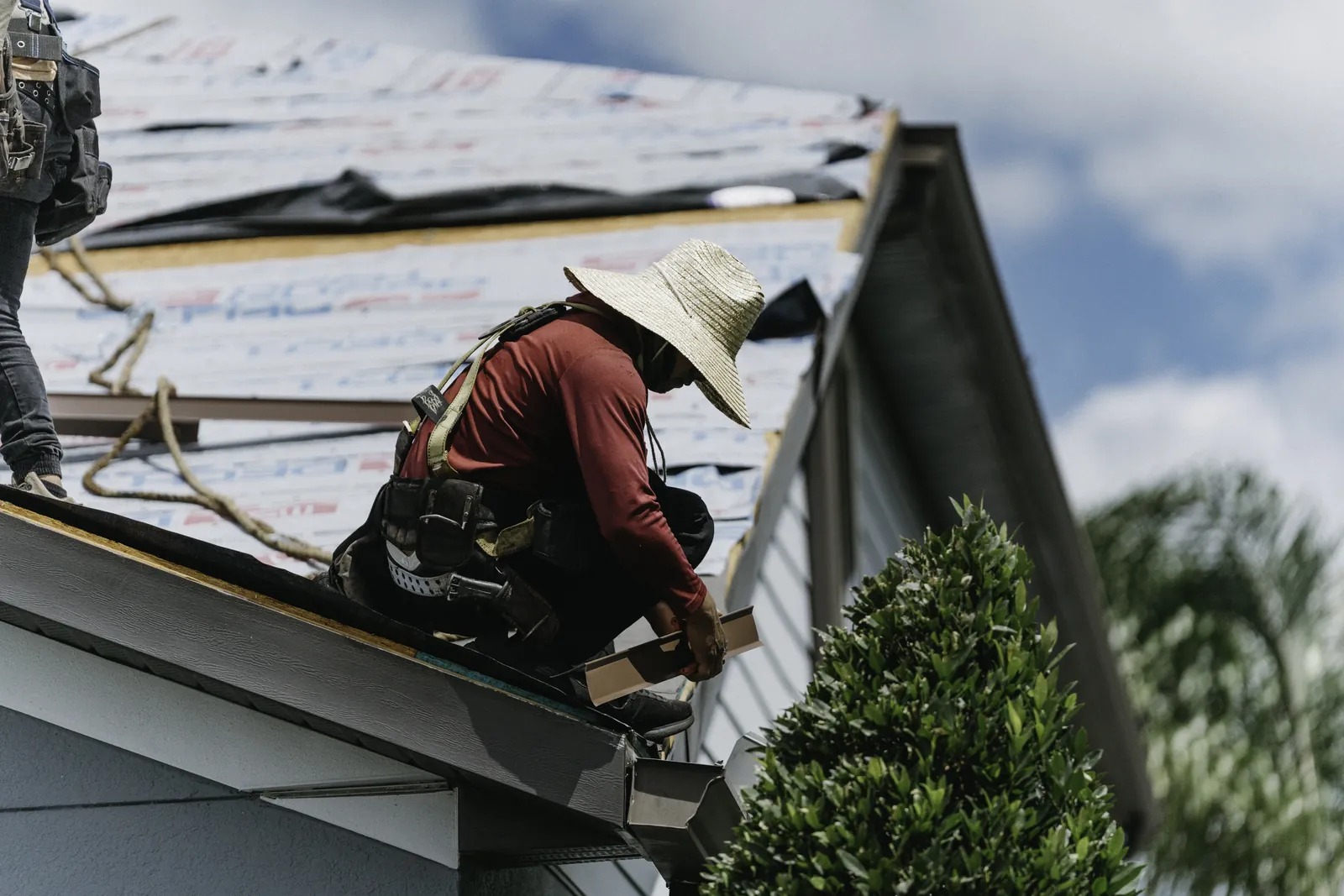 Roofer weatherproofing a dormer transition