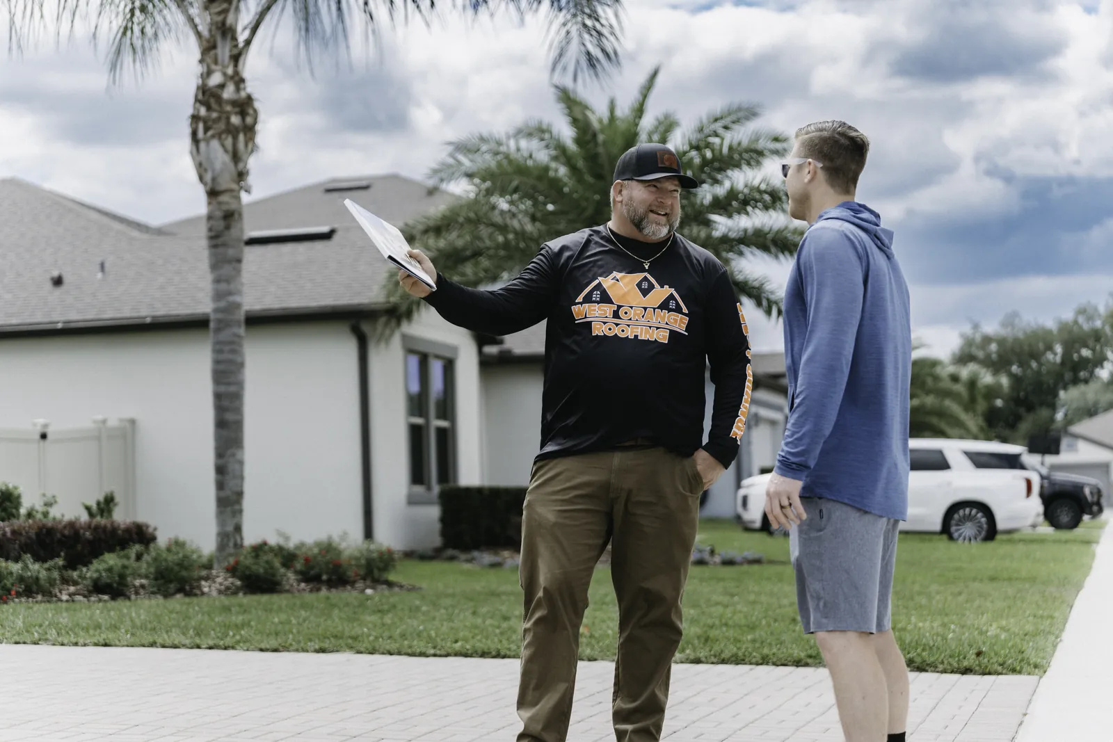 Roofing consultation with a homeowner outside a Central Florida home