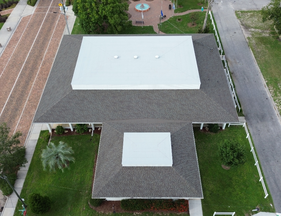 Aerial view of a commercial asphalt shingle installation completed by West Orange Roofing