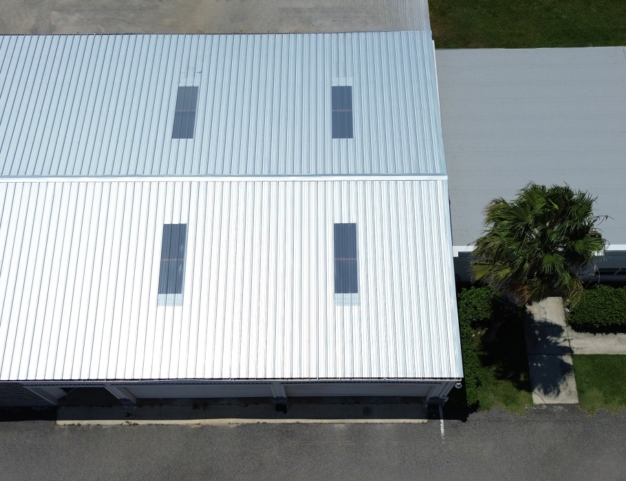 Aerial view of a commercial building in Williston, Florida with a new metal roof installed by West Orange Roofing