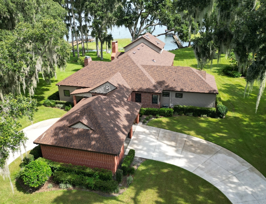 A lakeside home in Tavares, Florida with a new roof installed by West Orange Roofing