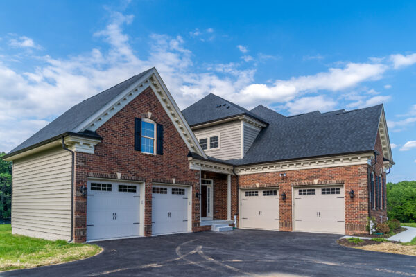 Residential brick home with asphalt shingle roof installed by top-rated roofing companies in Odessa, Florida